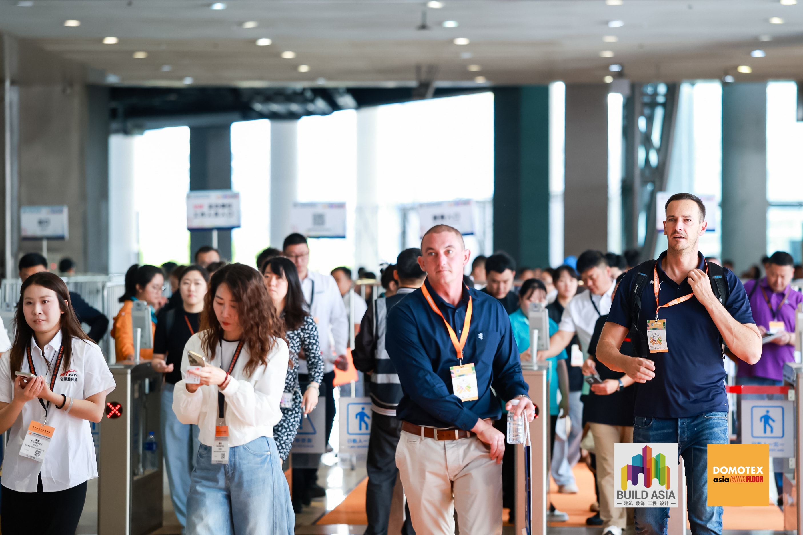 Visitors enter the trade fair through access gates, presenting their trade fair badges.